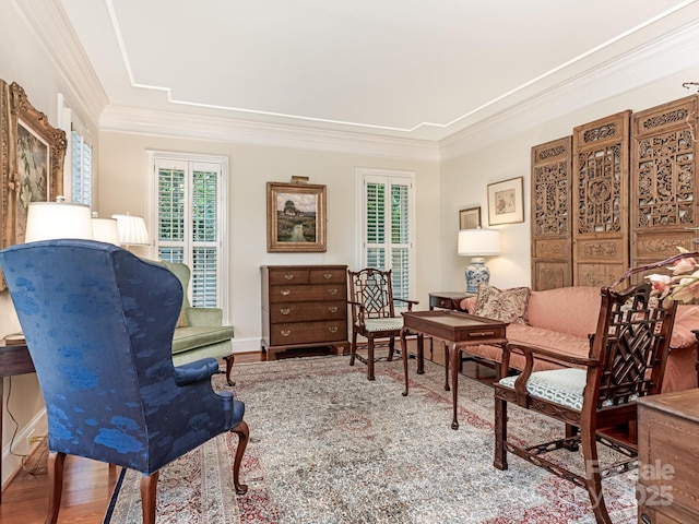 sitting room featuring ornamental molding and hardwood / wood-style floors