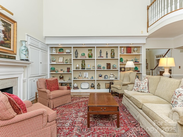 living room with built in features and a fireplace