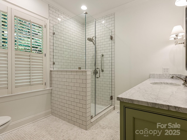 bathroom featuring tile patterned flooring, vanity, toilet, walk in shower, and crown molding