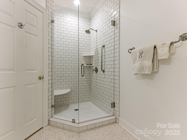 bathroom with an enclosed shower and tile patterned floors