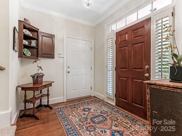 entrance foyer with dark wood-type flooring and crown molding