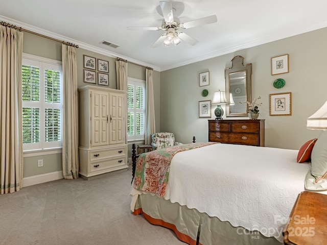 carpeted bedroom with ceiling fan, crown molding, and multiple windows