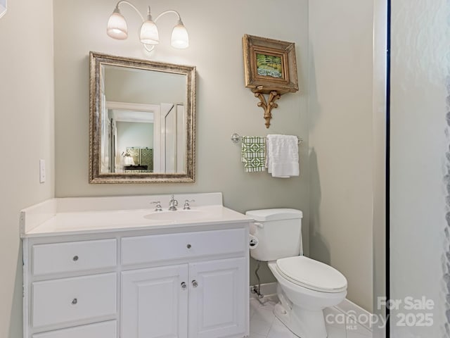 bathroom with toilet, tile patterned floors, and vanity