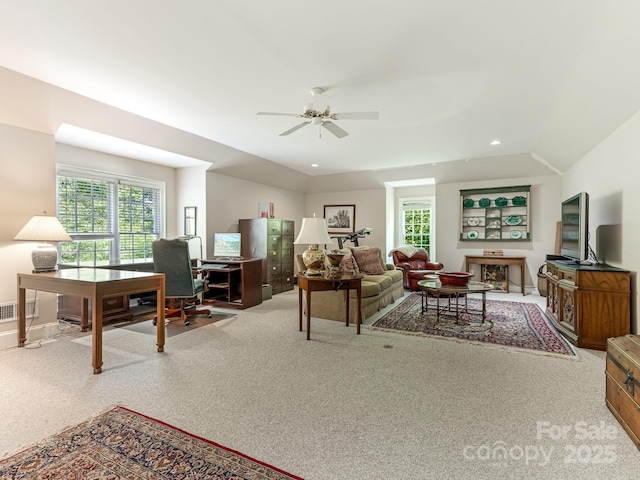 living room with ceiling fan and vaulted ceiling