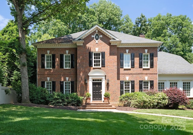 4301 Fairview Oaks Dr, Charlotte, NC 28211 - colonial-style house with a front lawn, a chimney, brick siding, and a shingled roof