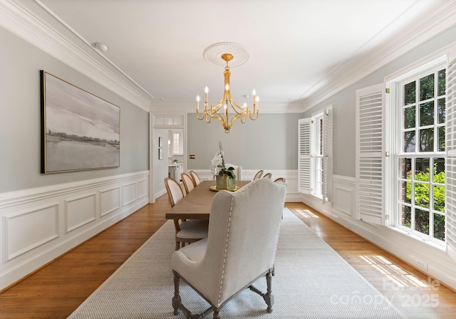 4301 Fairview Oaks Dr, Charlotte, NC 28211 - dining room with plenty of natural light, a chandelier, crown molding, wood finished floors, and wainscoting