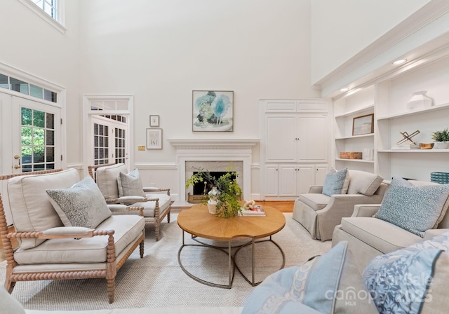 4301 Fairview Oaks Dr, Charlotte, NC 28211 - living area featuring a towering ceiling, healthy amount of natural light, and a fireplace