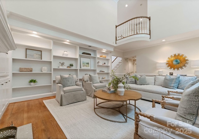 4301 Fairview Oaks Dr, Charlotte, NC 28211 - living area featuring light wood-type flooring, stairs, a high ceiling, ornamental molding, and recessed lighting