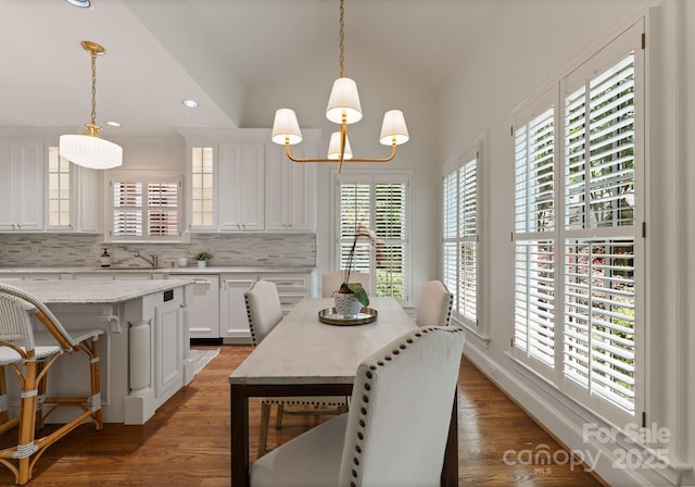 4301 Fairview Oaks Dr, Charlotte, NC 28211 - dining room with lofted ceiling, dark wood-style floors, recessed lighting, and a chandelier
