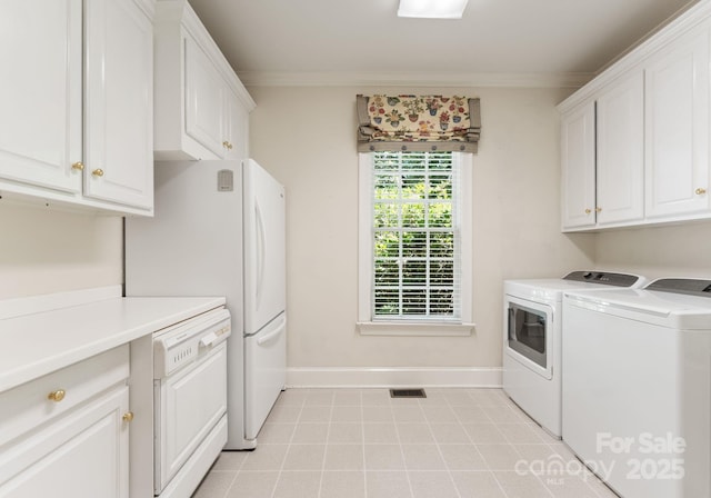 4301 Fairview Oaks Dr, Charlotte, NC 28211 - laundry area featuring washing machine and dryer, cabinet space, crown molding, baseboards, and light tile patterned flooring