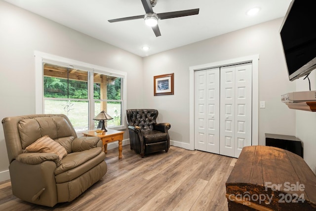 living area featuring ceiling fan and light wood-type flooring