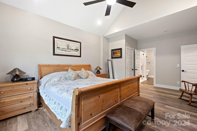 bedroom with ceiling fan, vaulted ceiling, hardwood / wood-style floors, and ensuite bath