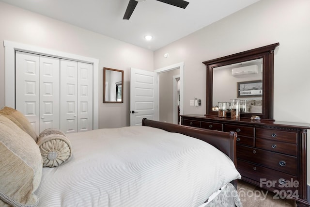 bedroom featuring ceiling fan, a closet, carpet floors, and an AC wall unit