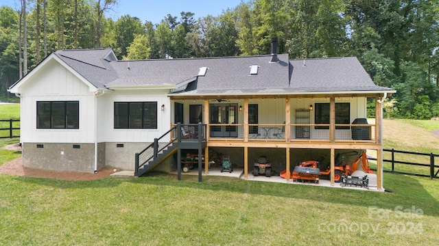 back of property featuring a patio area and a yard