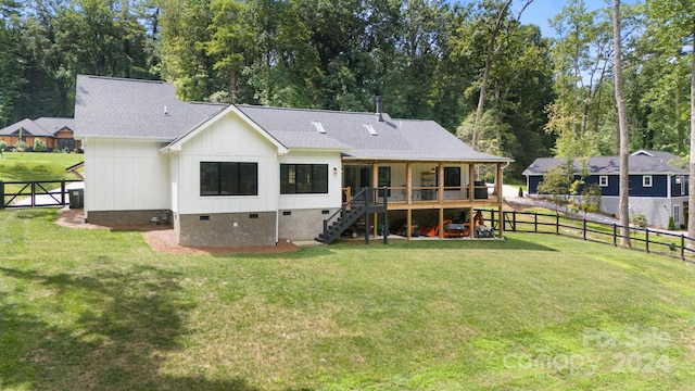 rear view of property with a lawn