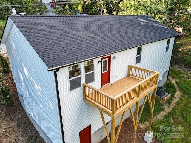 back of house featuring central AC unit and a wooden deck