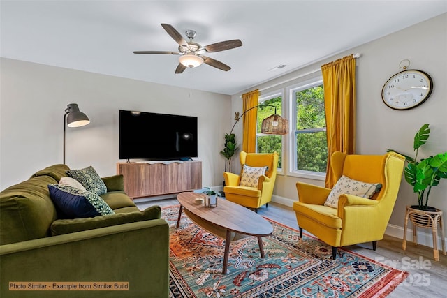 living room featuring ceiling fan and wood-type flooring