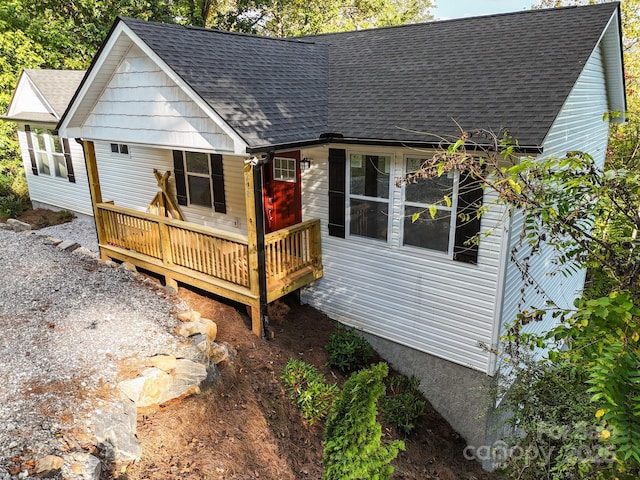 rear view of property featuring a deck