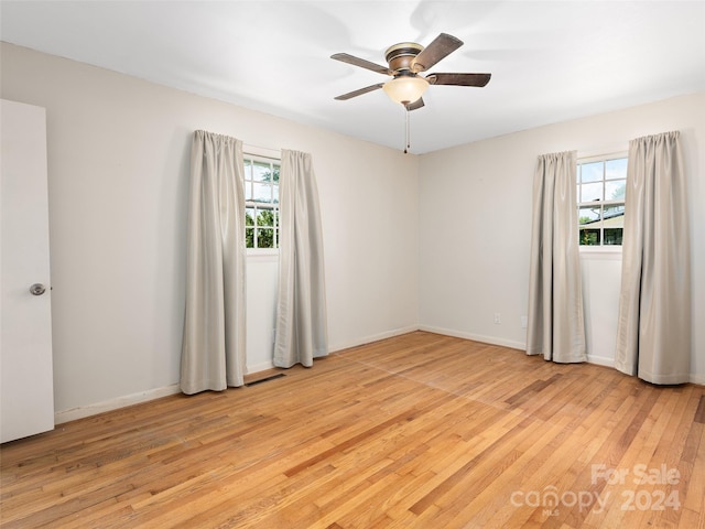 unfurnished room featuring ceiling fan and light wood-type flooring