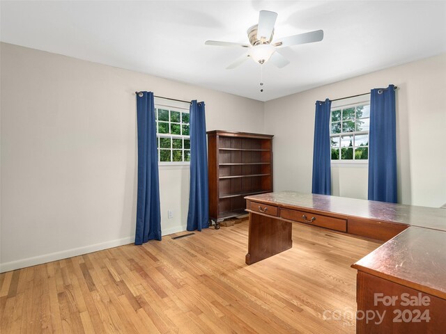 unfurnished office featuring ceiling fan and light hardwood / wood-style floors