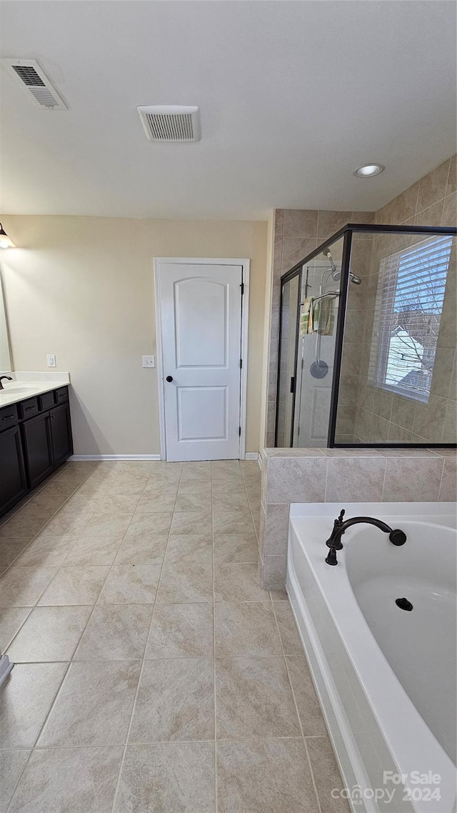 full bathroom with vanity, a shower stall, a bath, and visible vents