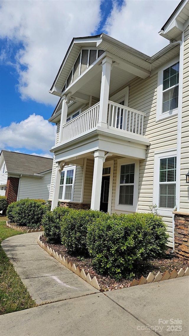 view of front of house featuring a balcony