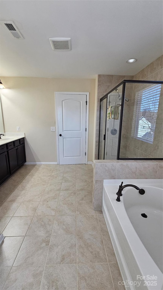 full bath featuring a shower stall, a garden tub, vanity, and visible vents