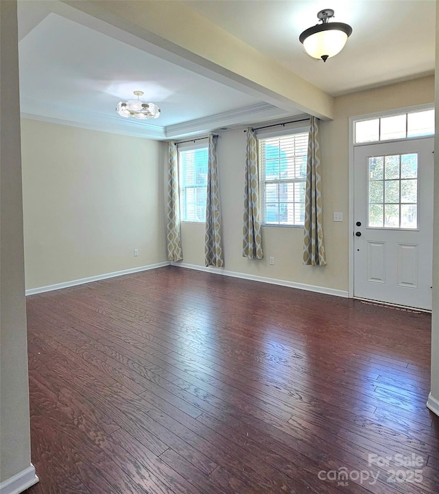 foyer with ornamental molding, baseboards, and hardwood / wood-style flooring