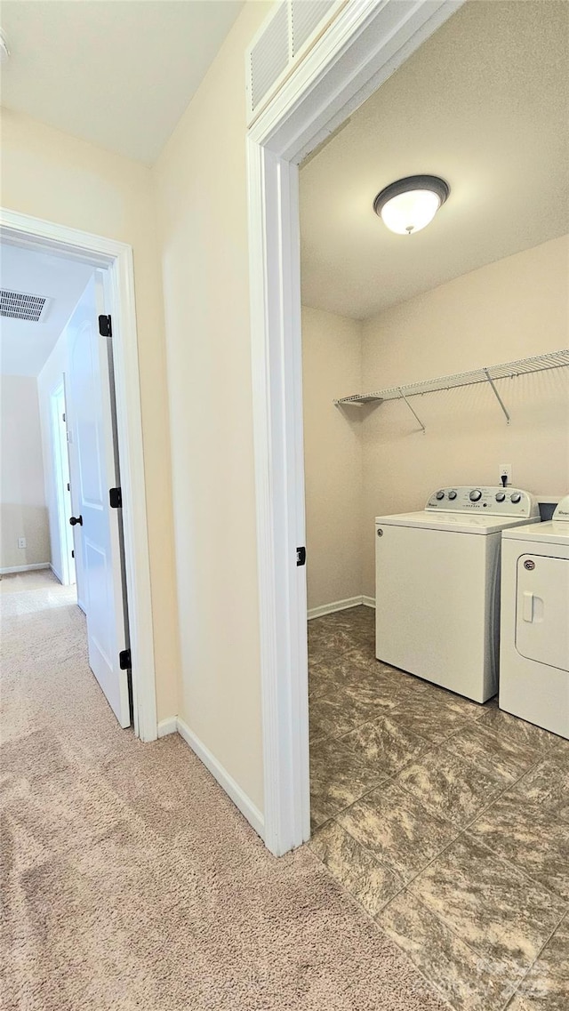 laundry room with baseboards, visible vents, laundry area, and washing machine and clothes dryer