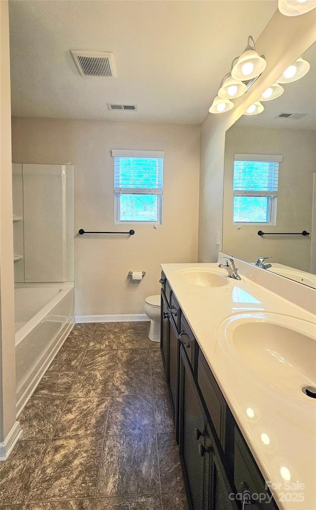 bathroom featuring a sink, visible vents, a wealth of natural light, and toilet
