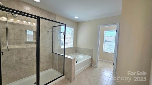 bathroom with a bath, a wealth of natural light, tile patterned flooring, and a stall shower