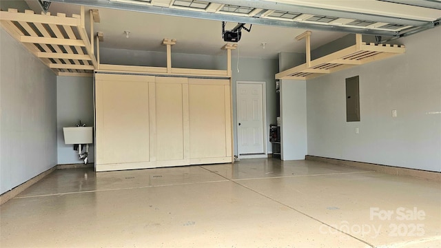 garage with electric panel, a garage door opener, baseboards, and a sink