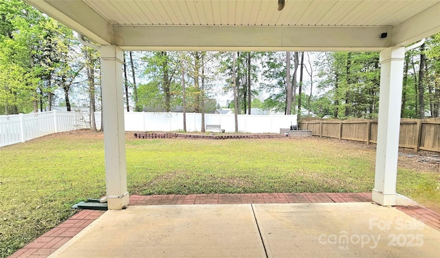 view of yard with a patio area and a fenced backyard