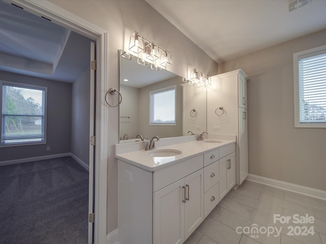 bathroom with dual vanity and tile patterned flooring