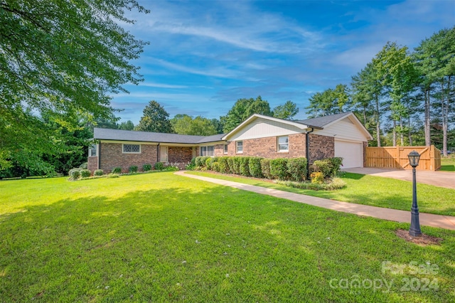 ranch-style home featuring a front yard and a garage