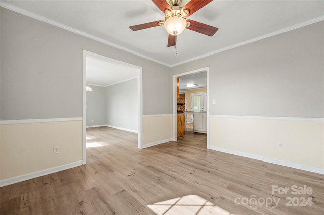 spare room featuring ceiling fan, wood-type flooring, and ornamental molding