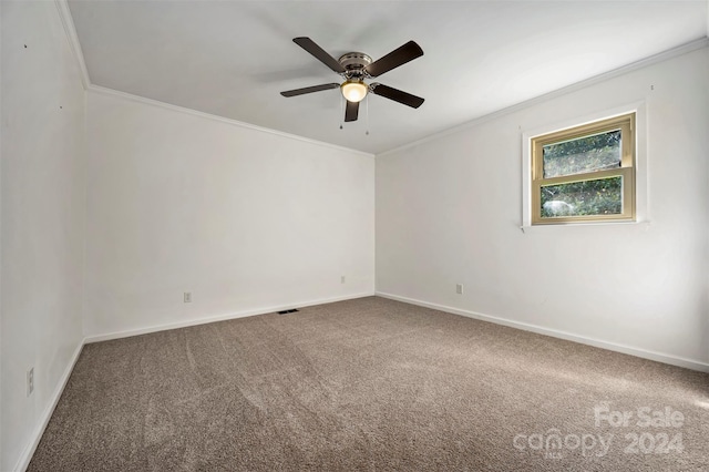 carpeted empty room with ceiling fan and crown molding