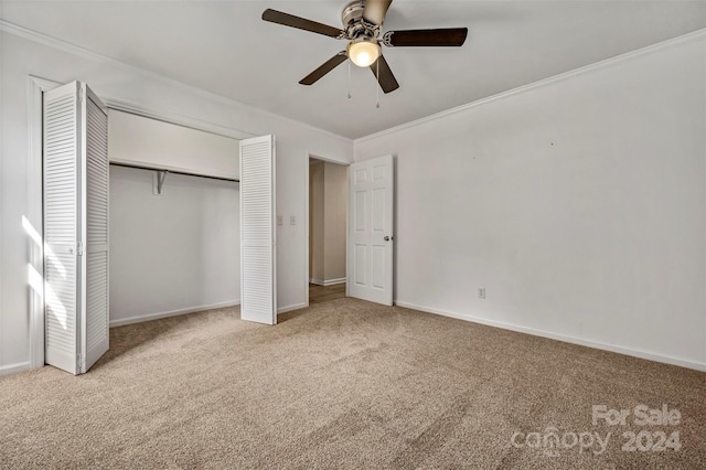 unfurnished bedroom with ceiling fan, light carpet, a closet, and crown molding