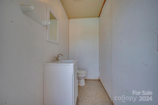 bathroom featuring toilet and vanity