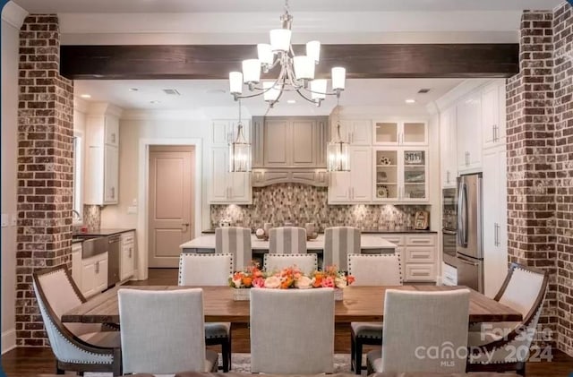 dining area featuring beamed ceiling, a chandelier, and hardwood / wood-style flooring