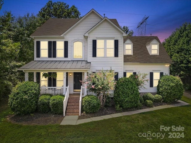 view of front of home featuring a yard and covered porch