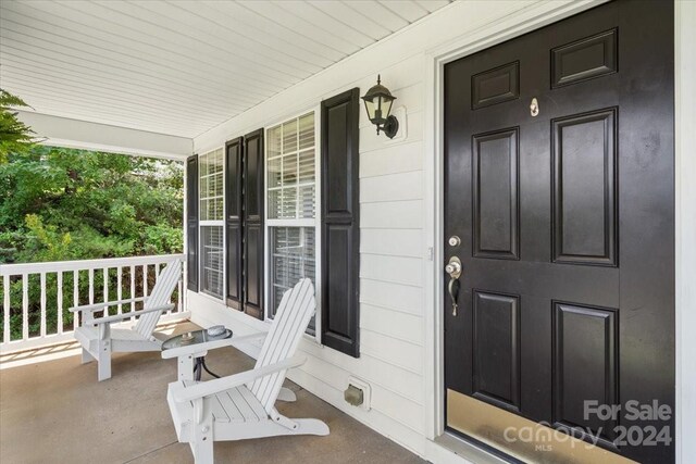 doorway to property with a porch