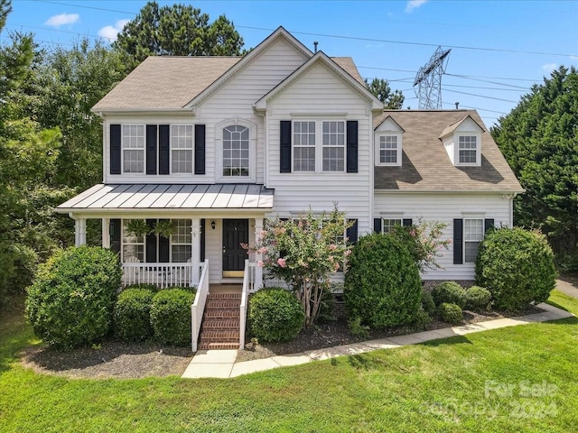 view of front of house featuring a front yard and covered porch