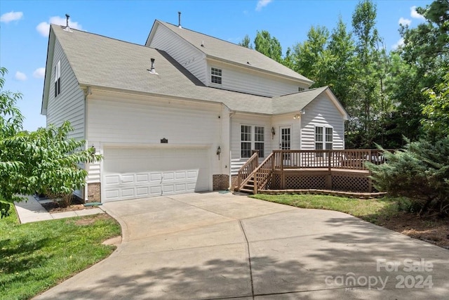 view of front of home with a garage and a deck