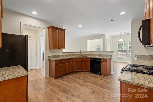 kitchen with sink, decorative light fixtures, light hardwood / wood-style flooring, and black appliances