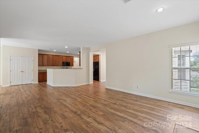 unfurnished living room featuring hardwood / wood-style floors