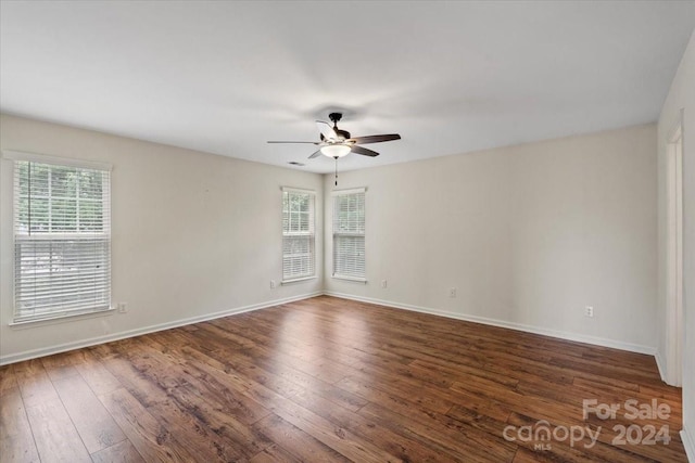 spare room featuring dark hardwood / wood-style floors and ceiling fan