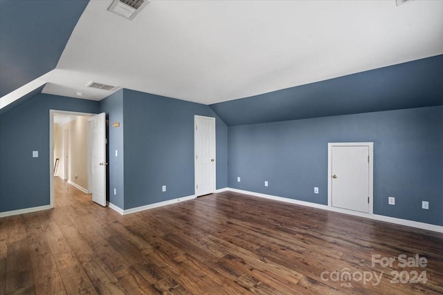 additional living space featuring hardwood / wood-style flooring and lofted ceiling