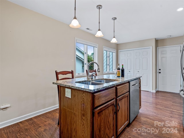 kitchen with dark wood-style floors, a sink, hanging light fixtures, and stainless steel dishwasher