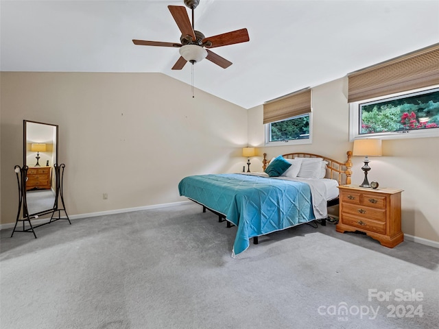 carpeted bedroom featuring baseboards, vaulted ceiling, and a ceiling fan